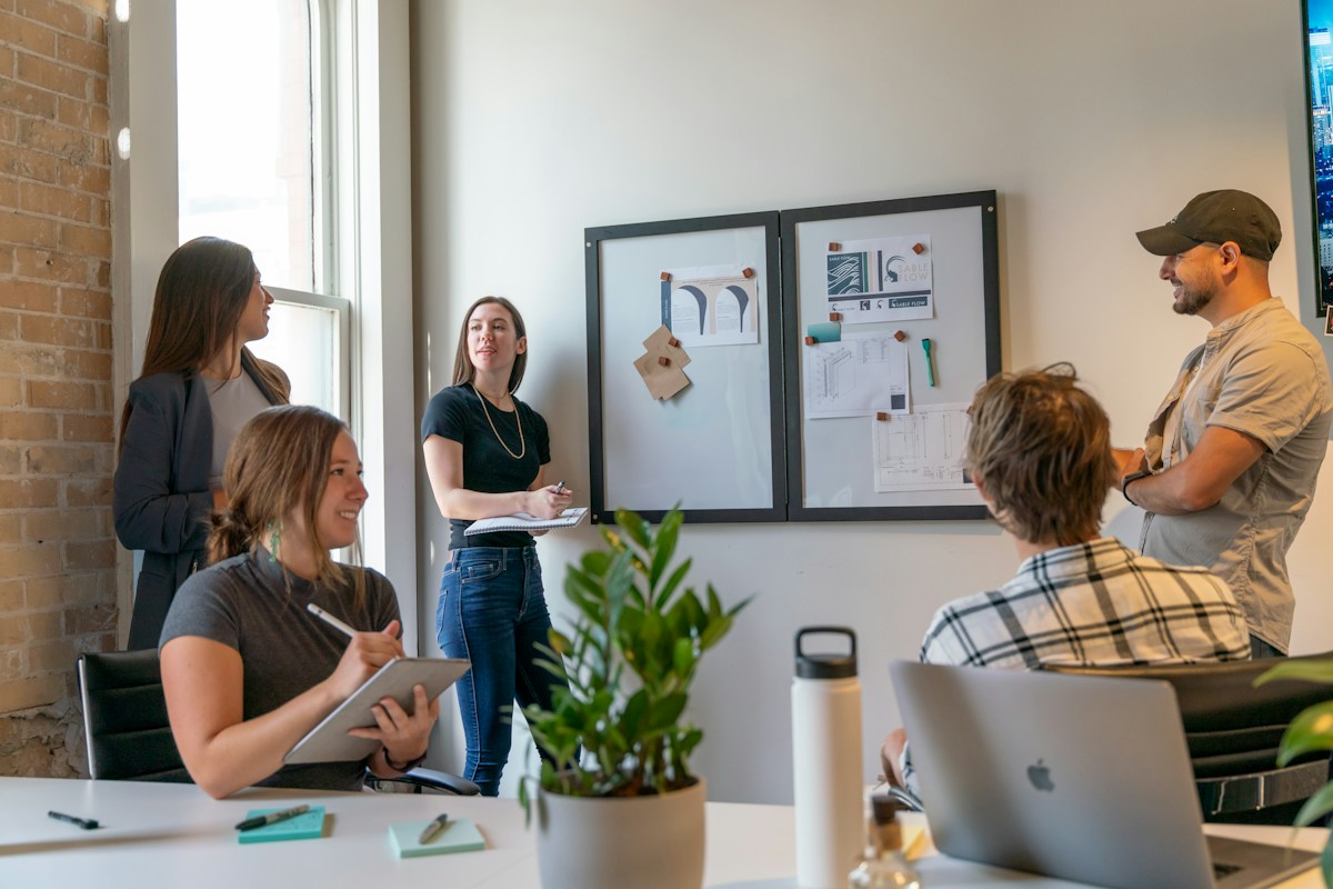 Colleagues developing a plan at a whiteboard